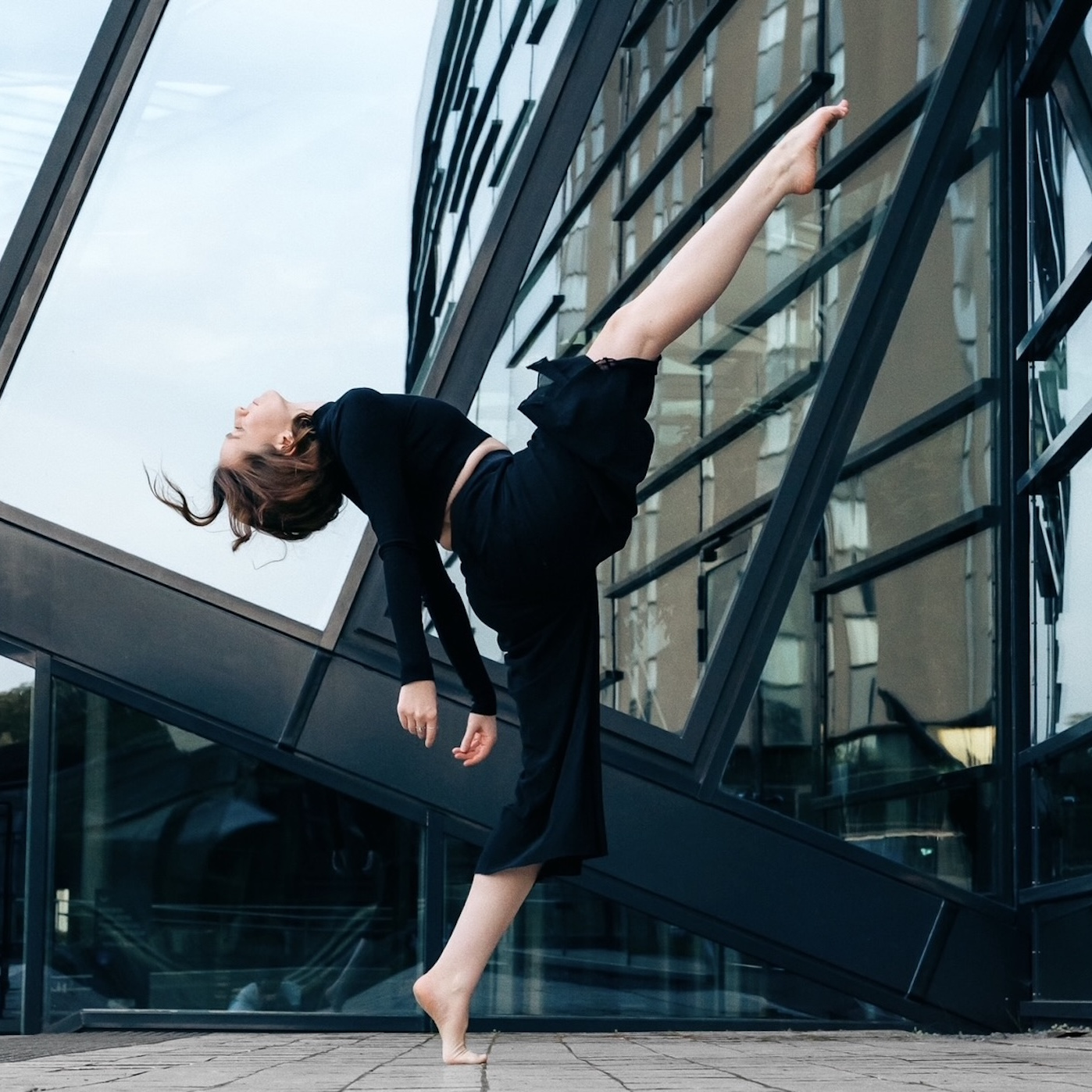 Modern-Dance-Pose von Marina Rosenstein vor einer Glasfront outdoor